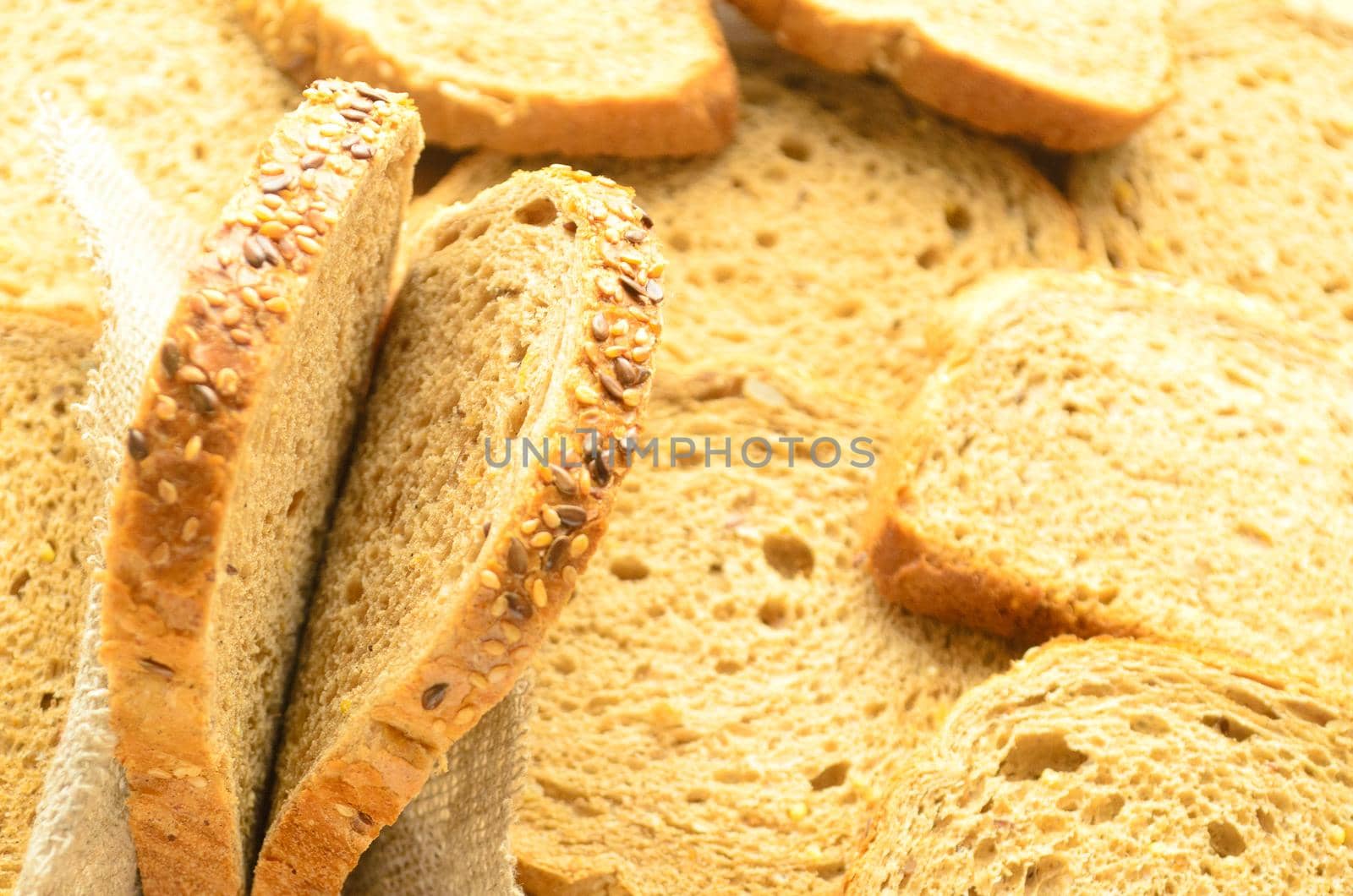 Two slices of cereal bread on bread background,copyspace.