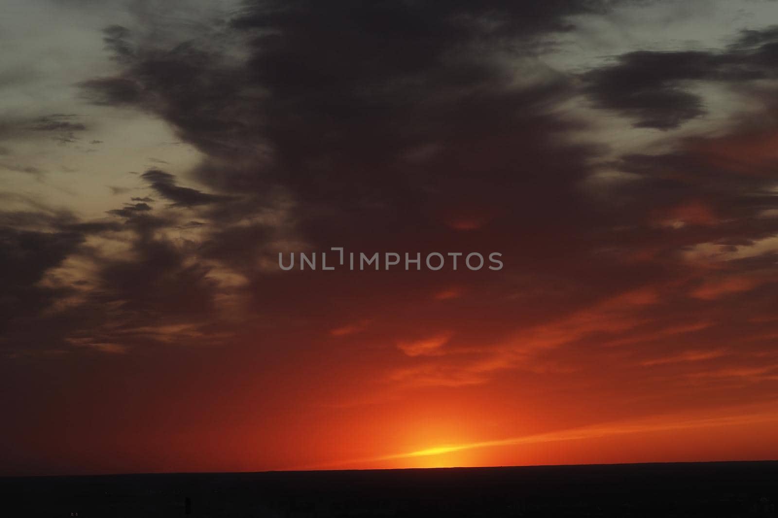 It's a beautiful sunset. Night sky with clouds and the setting sun on the horizon. High quality photo