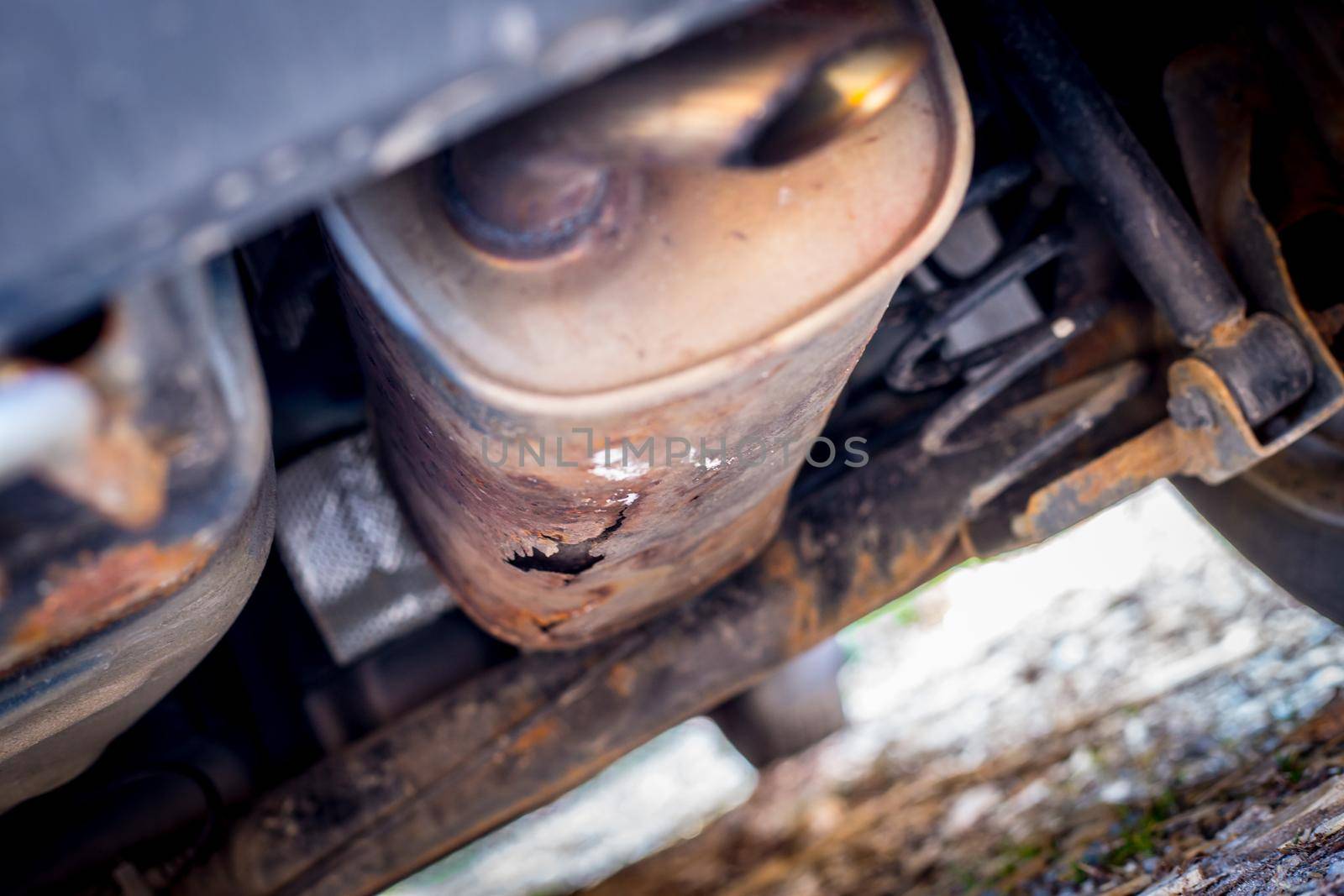 Environmental pollution concept: Close up of old rust eaten exhaust pipe by Daxenbichler
