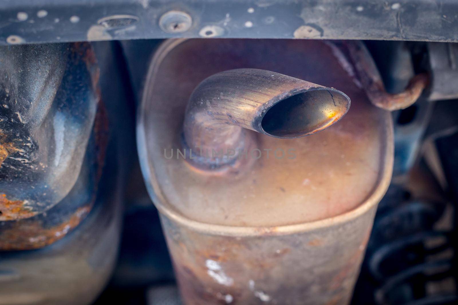 Environmental pollution concept: Close up of old rust eaten exhaust pipe by Daxenbichler