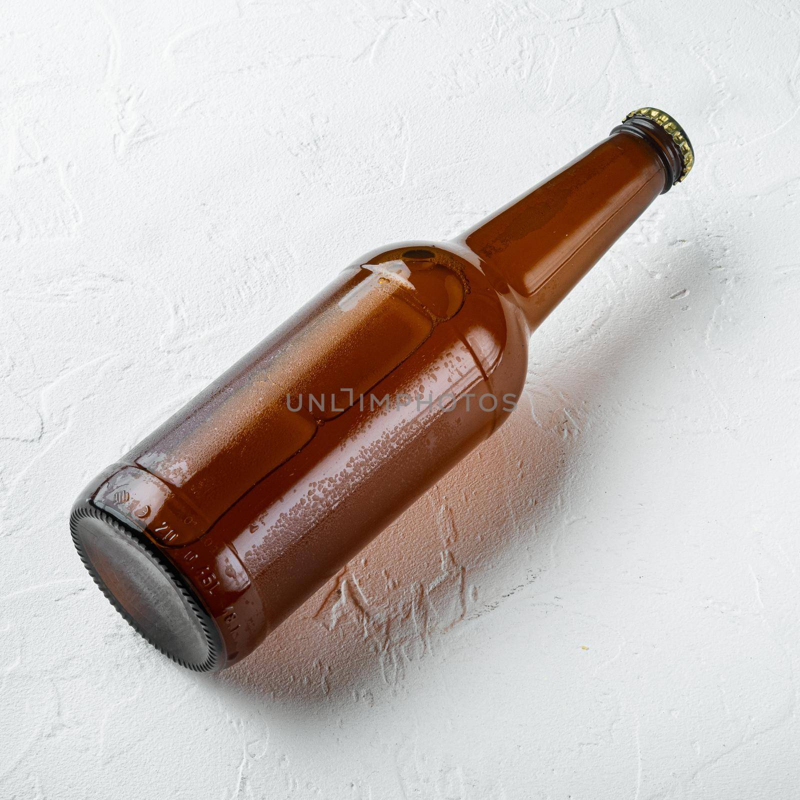 Fresh beer in glass bottles, on white stone surface, square format by Ilianesolenyi