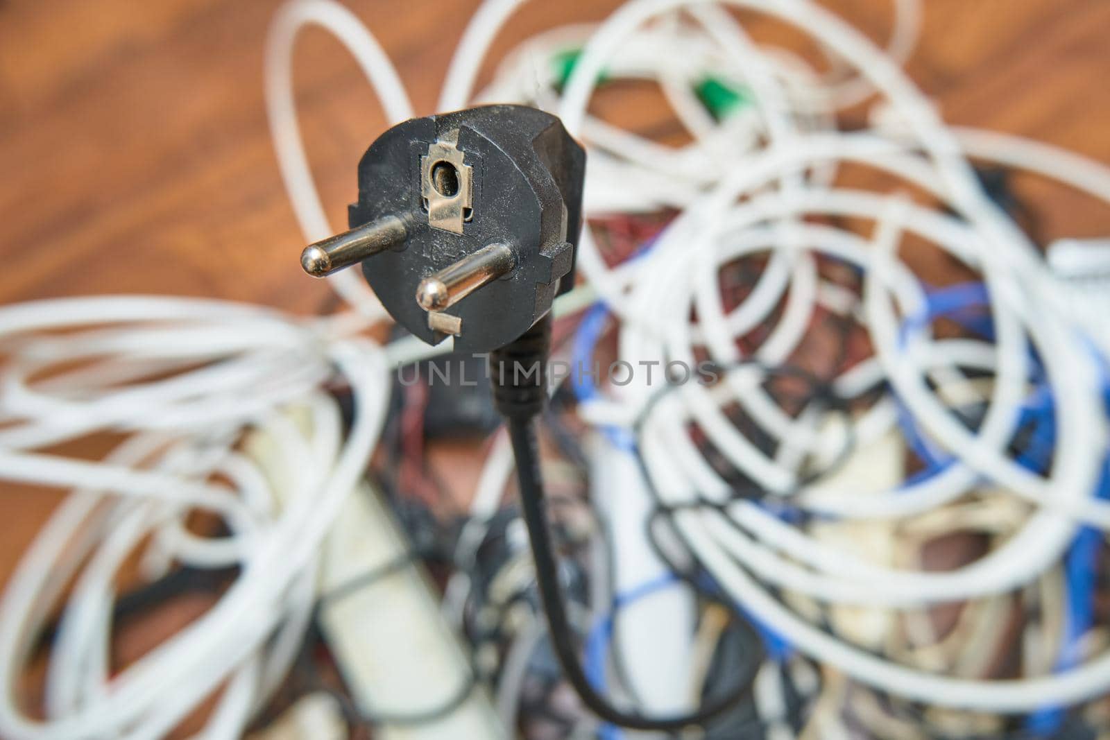 A tangled tangle of unnecessary wires lies on the floor.