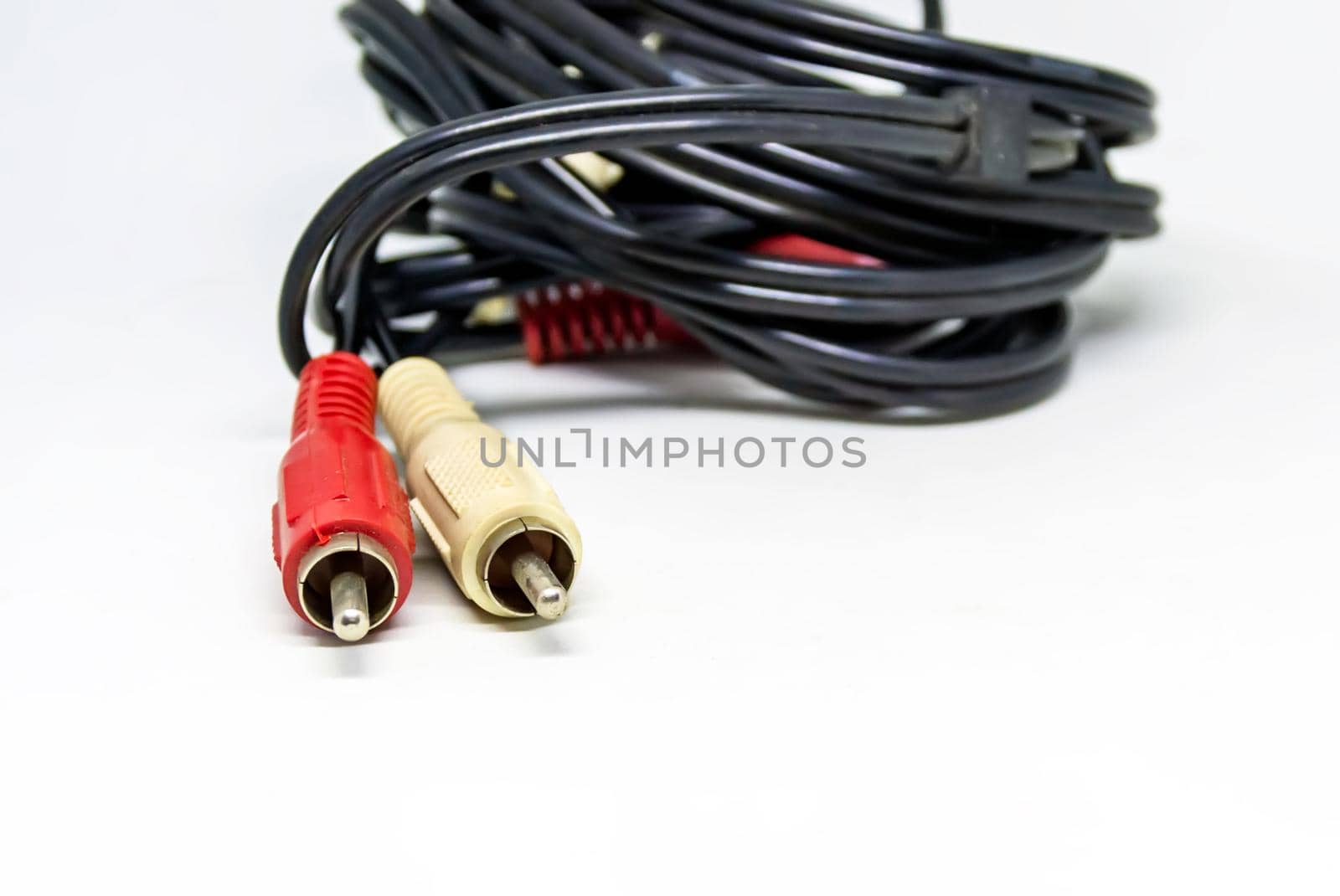 Two red and white audio RCA plugs isolated on a white background. Analog technology by rarrarorro