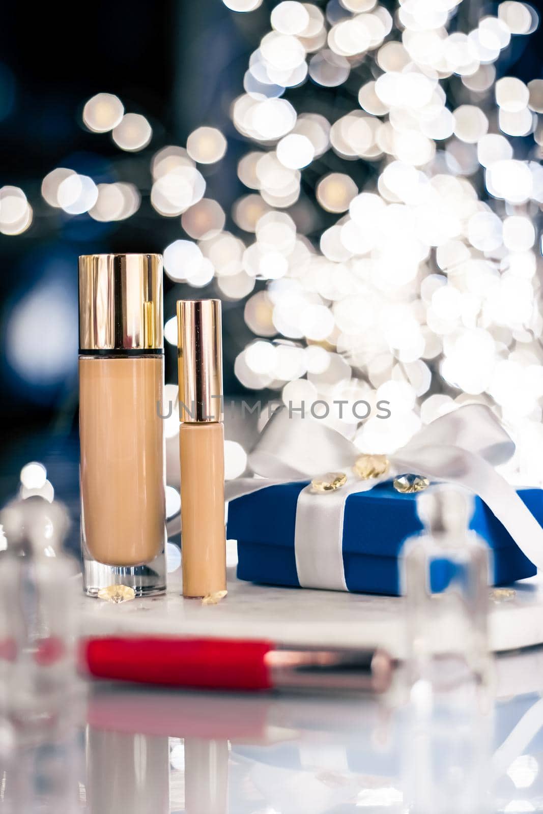 Cosmetic branding, Christmas glitter and girly blog concept - Holiday make-up foundation base, concealer and blue gift box, luxury cosmetics present and blank label products for beauty brand design