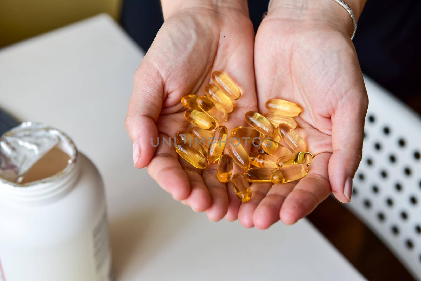 Hands holding fish oil Omega-3 capsules. Medical healthcare, healthy nutrition supplements concept. Vitamin tablets.