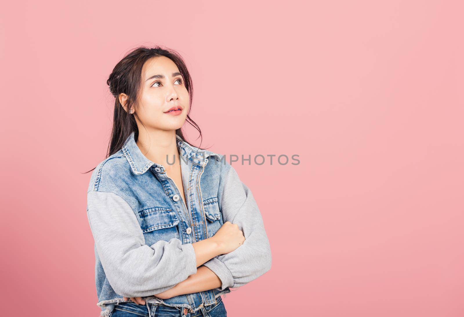 woman wear denim standing her smile confidence with crossed arms by Sorapop