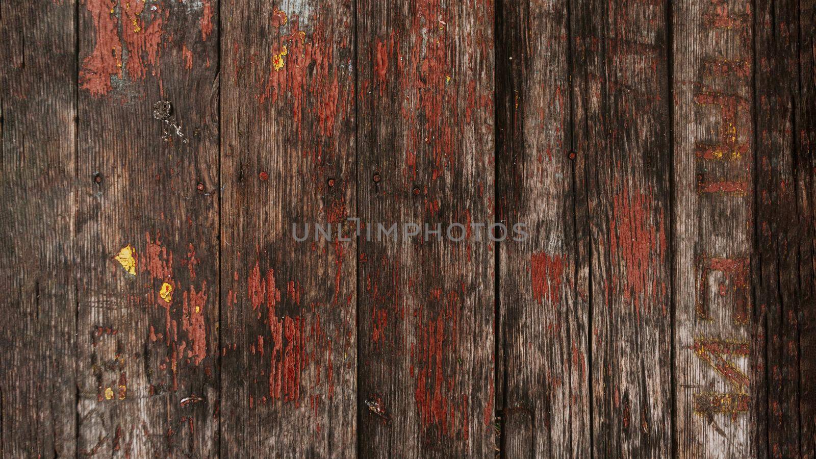 Brown wood texture with cracked paint residues.Abstract background,blank template.rustic weathered wood barn background with knots and nail holes.Cover the walls with wooden planks.Copy space.