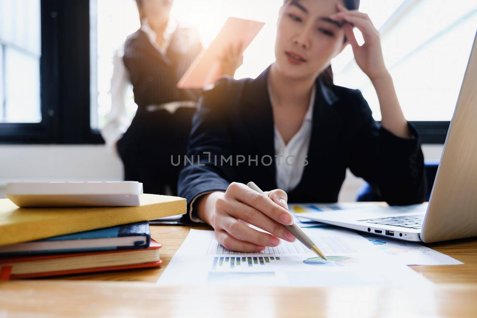 Stressed business woman hard working until morning and tired at table in office while project deadlines. finance, account, tax, audit concept