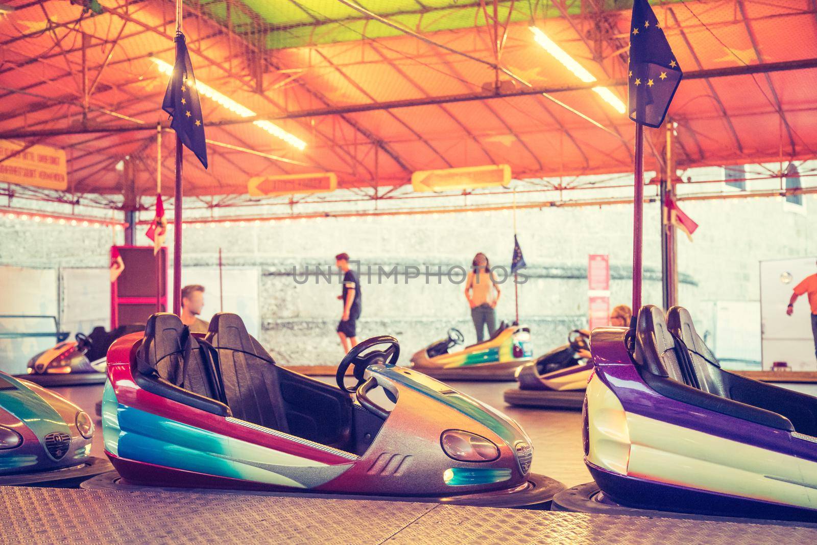 Bumper car at Oktoberfest: Colorful electric bumper car in autodrom by Daxenbichler