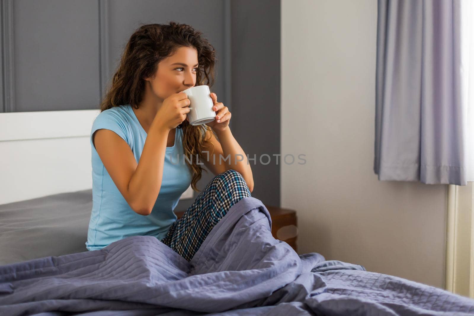 Woman  drinking coffee in  bed. by Bazdar