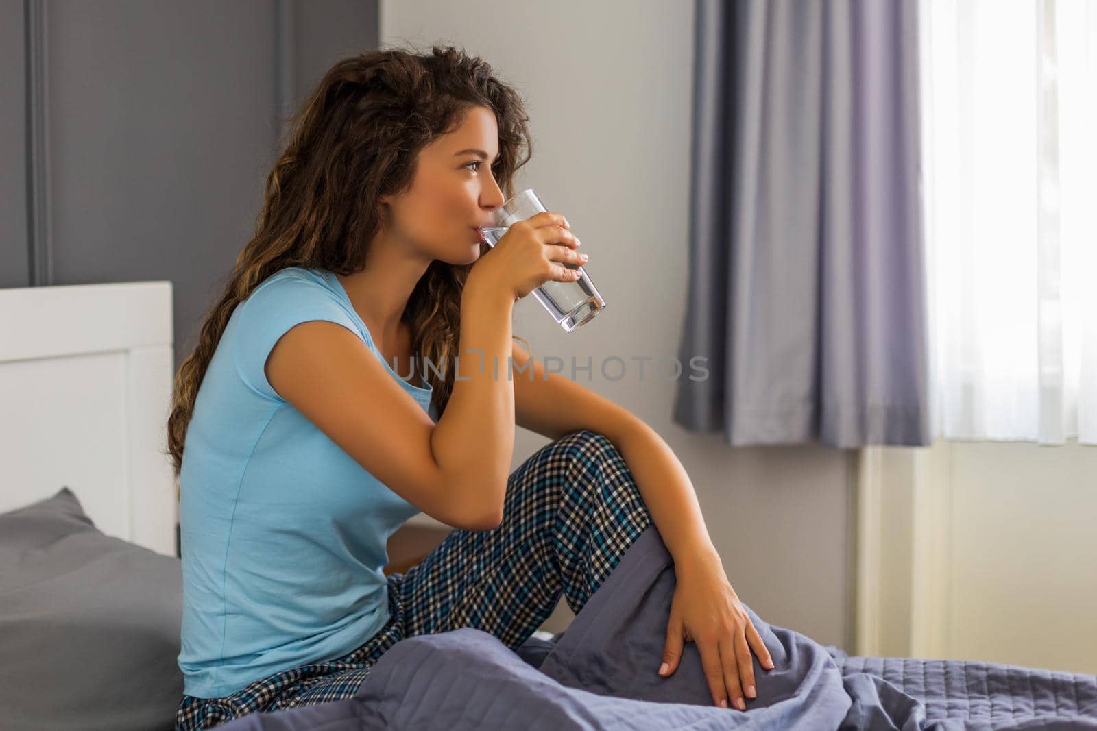 Woman drinking water by Bazdar