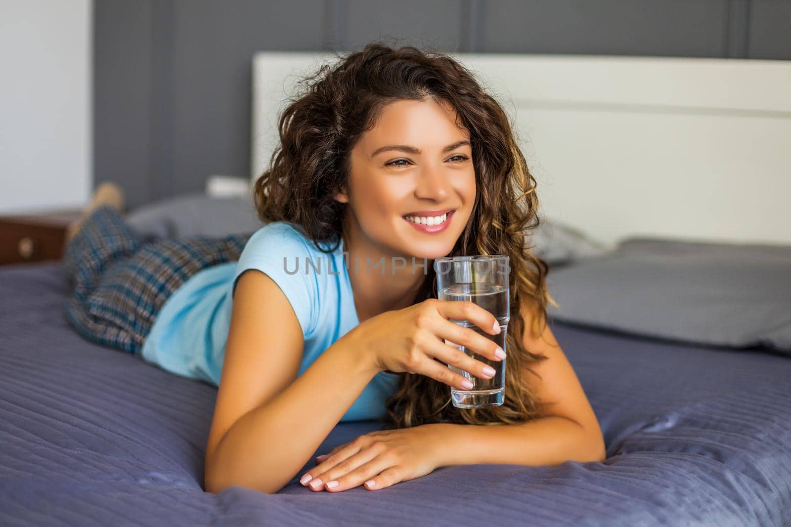 Beautiful woman enjoys  drinking water.