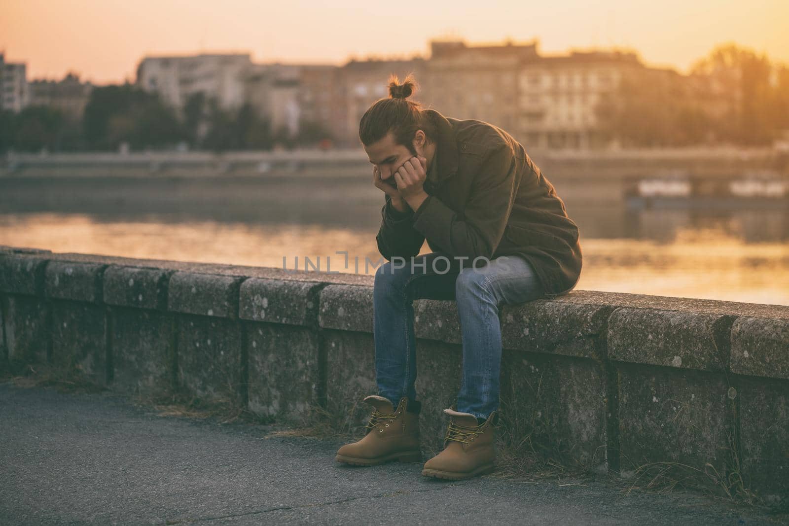 Depressed  businessman sitting by the river by Bazdar