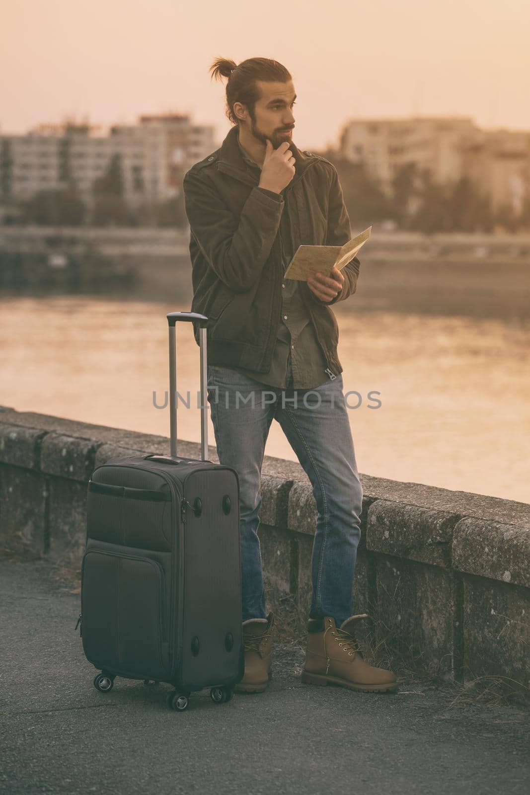 Businessman with suitcase and city map standing lost by Bazdar