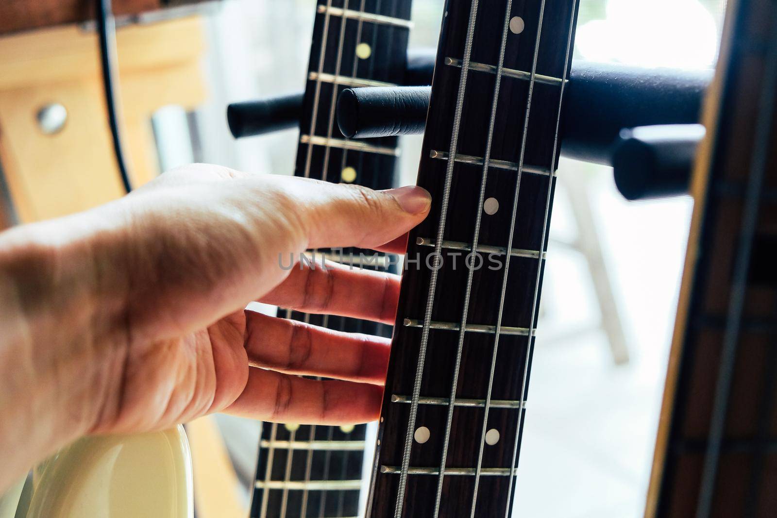 close up Image of Hand picking up guitar