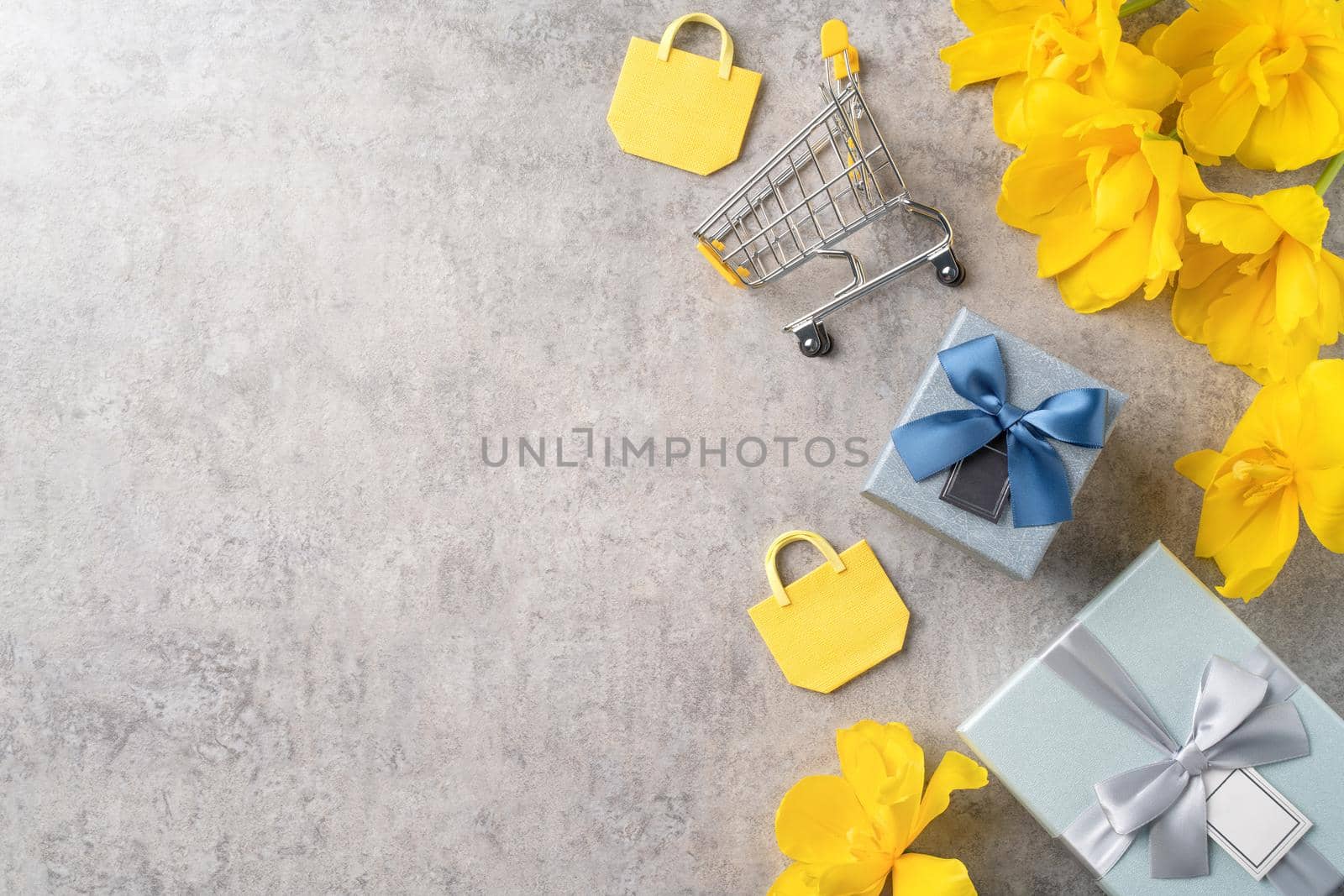 Concept of Mother's day holiday gift shopping greeting design with yellow tulip flower bouquet on gray background