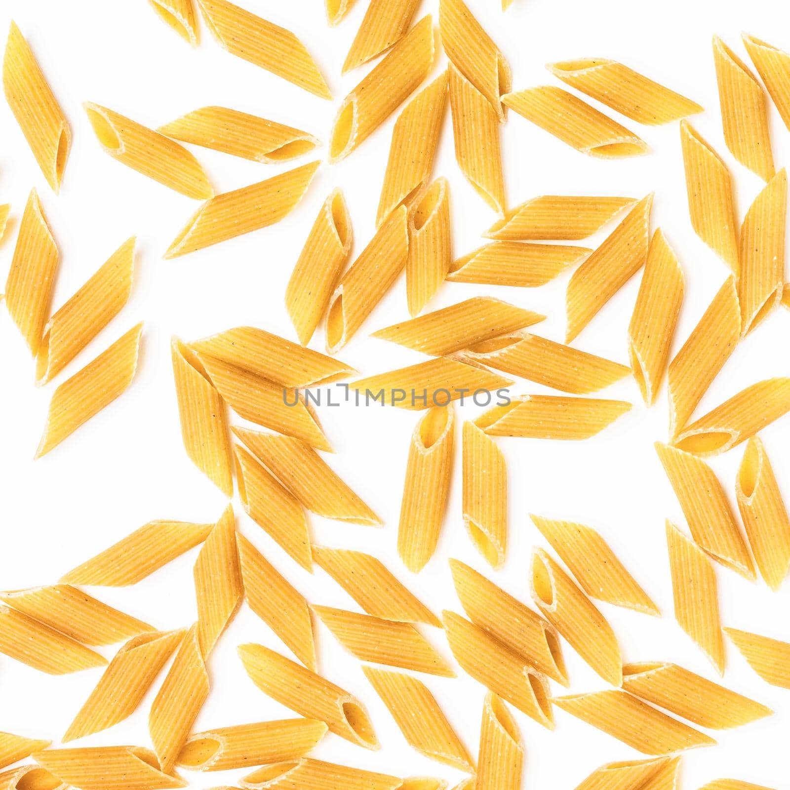Penne rigate pasta. Pasta on white background. Dry penne rigate pasta isolated over white. Top view.
