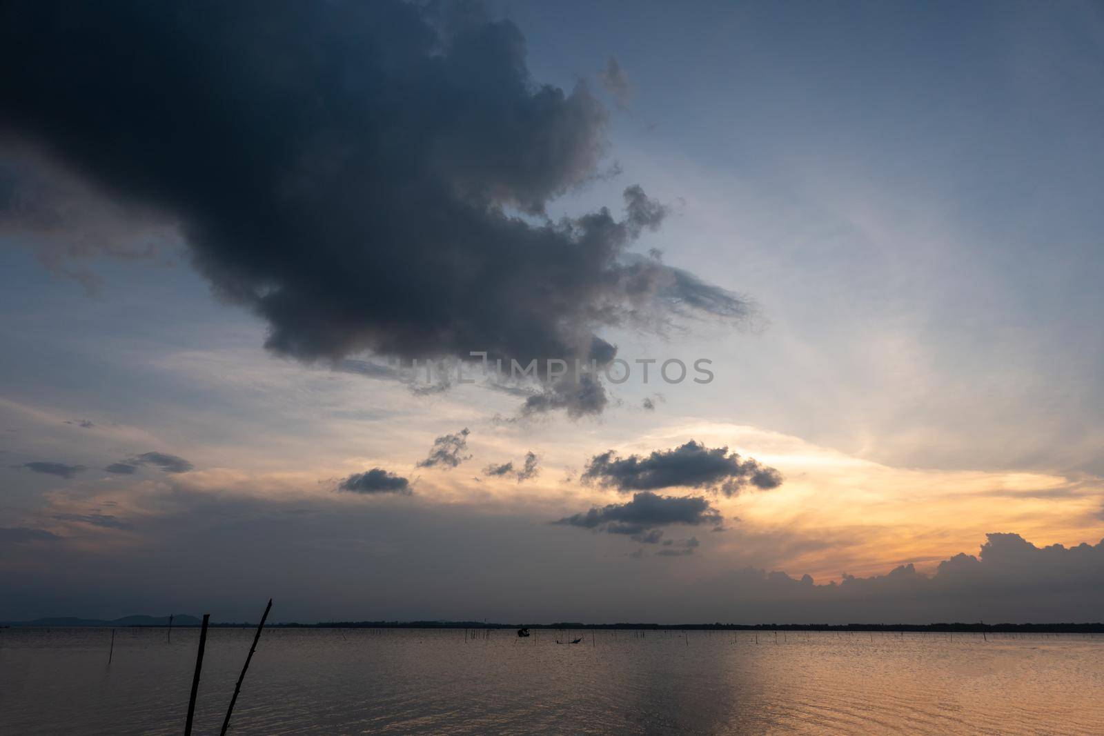 sunset over the sea with cloudy sky