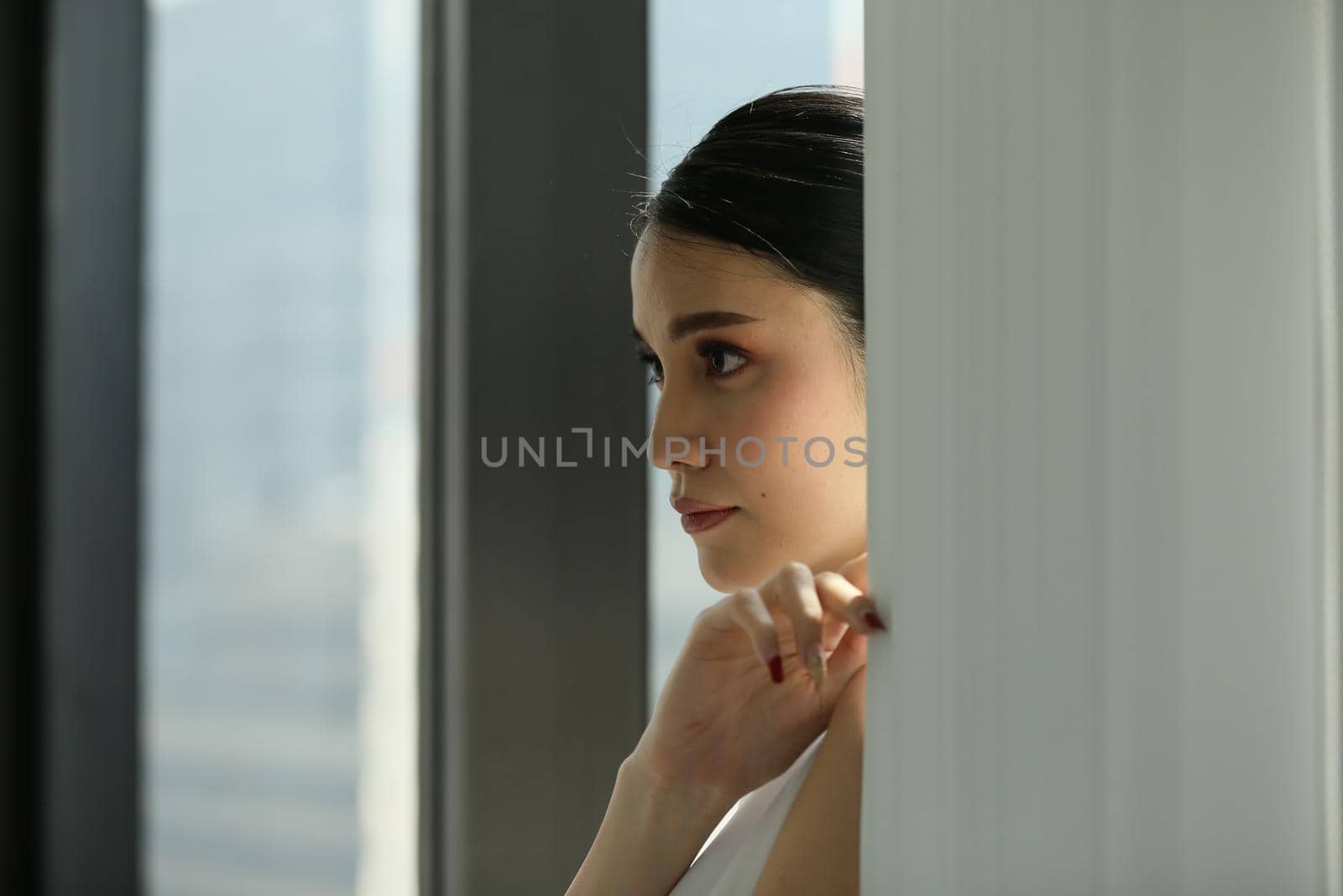 Side view of businesswoman looking through window.