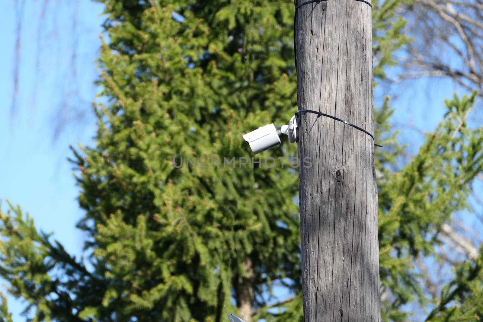 Outdoor security camera on a pole in the open air. by Olga26