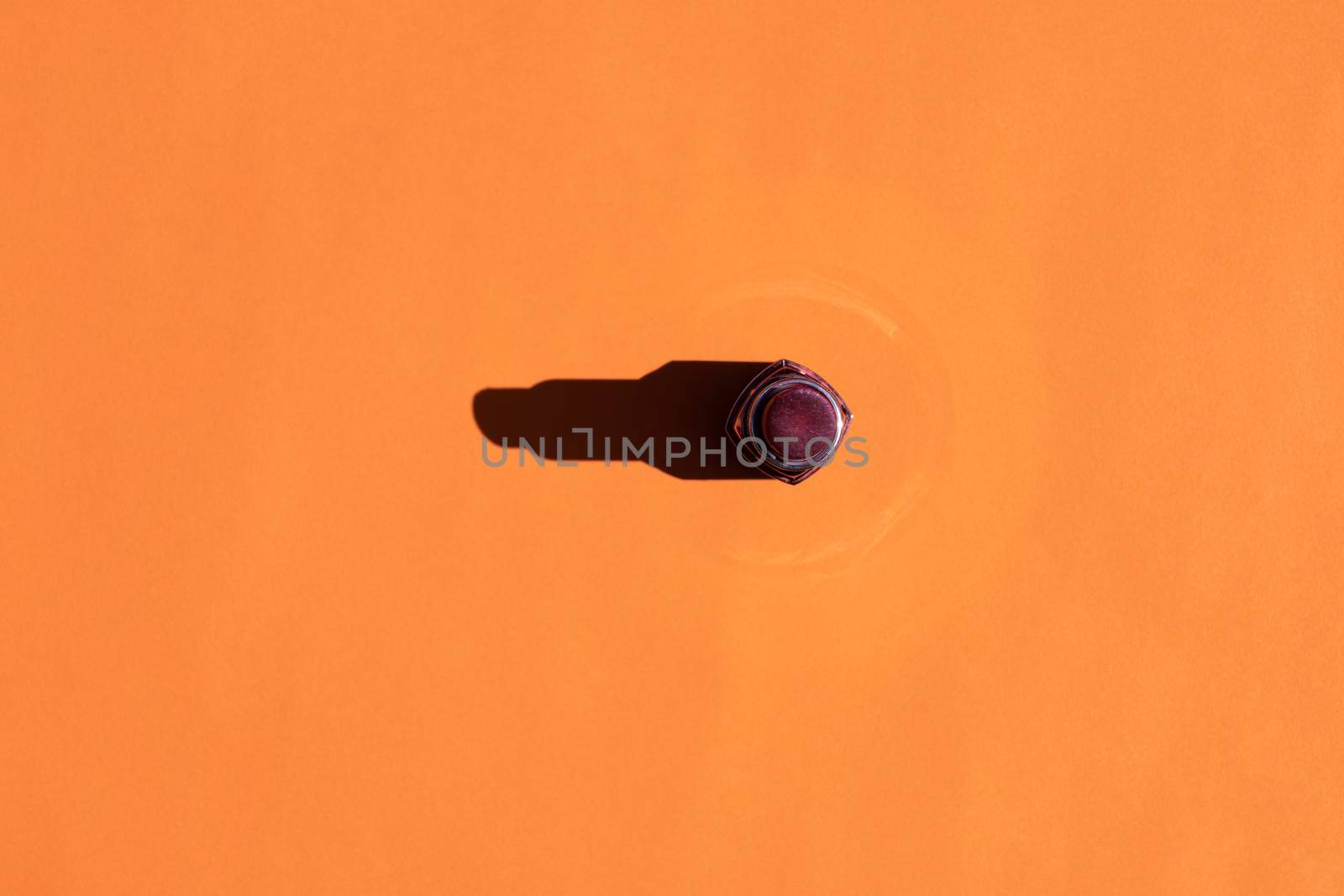 lipstick with a hard shadow on a colorful background. High quality photo