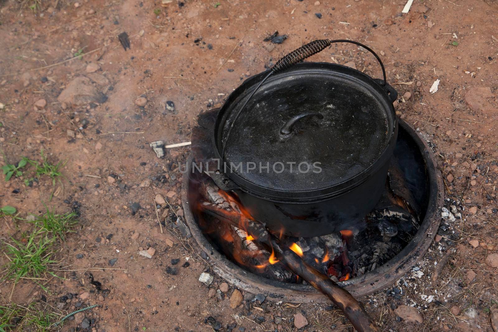Campfire meal cooking in a dutch oven by rustycanuck