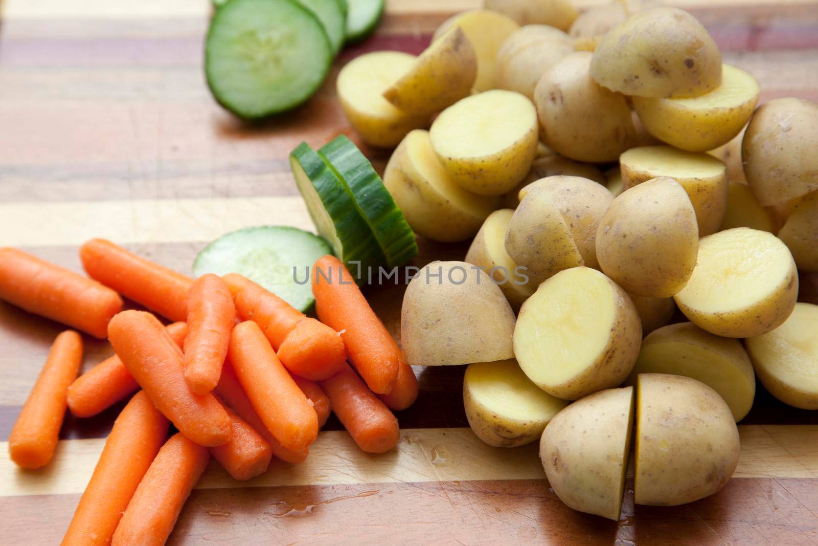 Side view of fresh vegetables on a wooden cutting board 