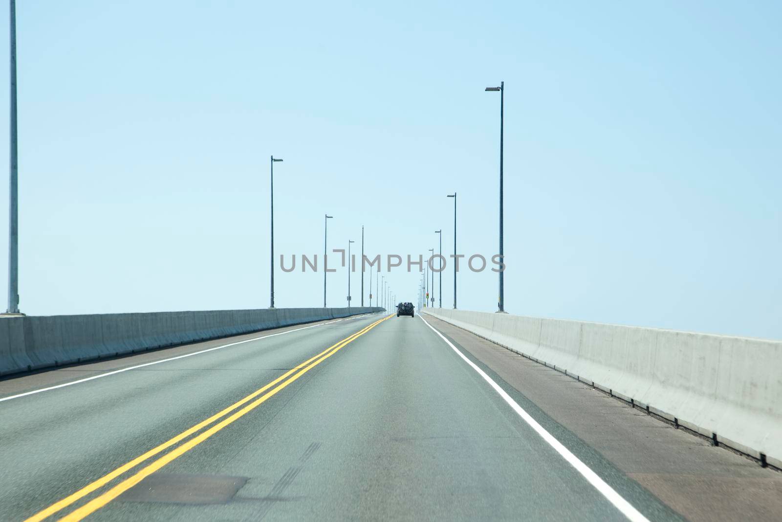 Confederation Bridge, PEI - July 28, 2019: Following a car along the Confederation Bridge in PEI on a summer day 