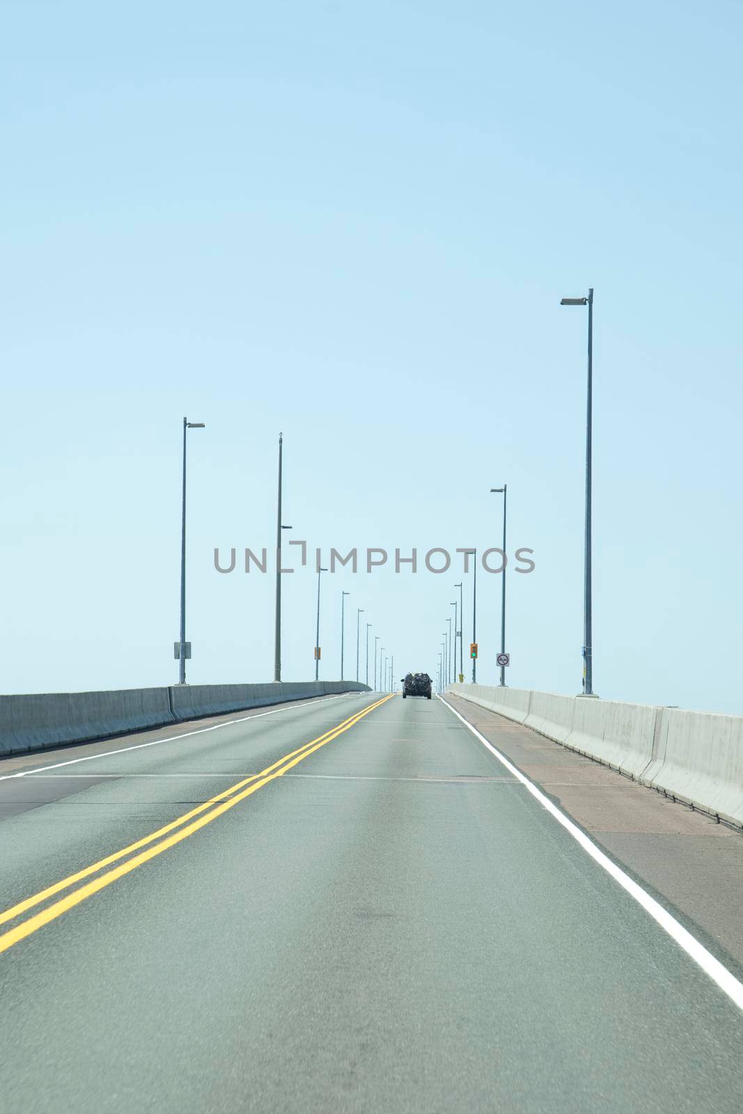 Confederation Bridge, PEI - July 28, 2019: A car along the Confederation Bridge in PEI on a summer day 