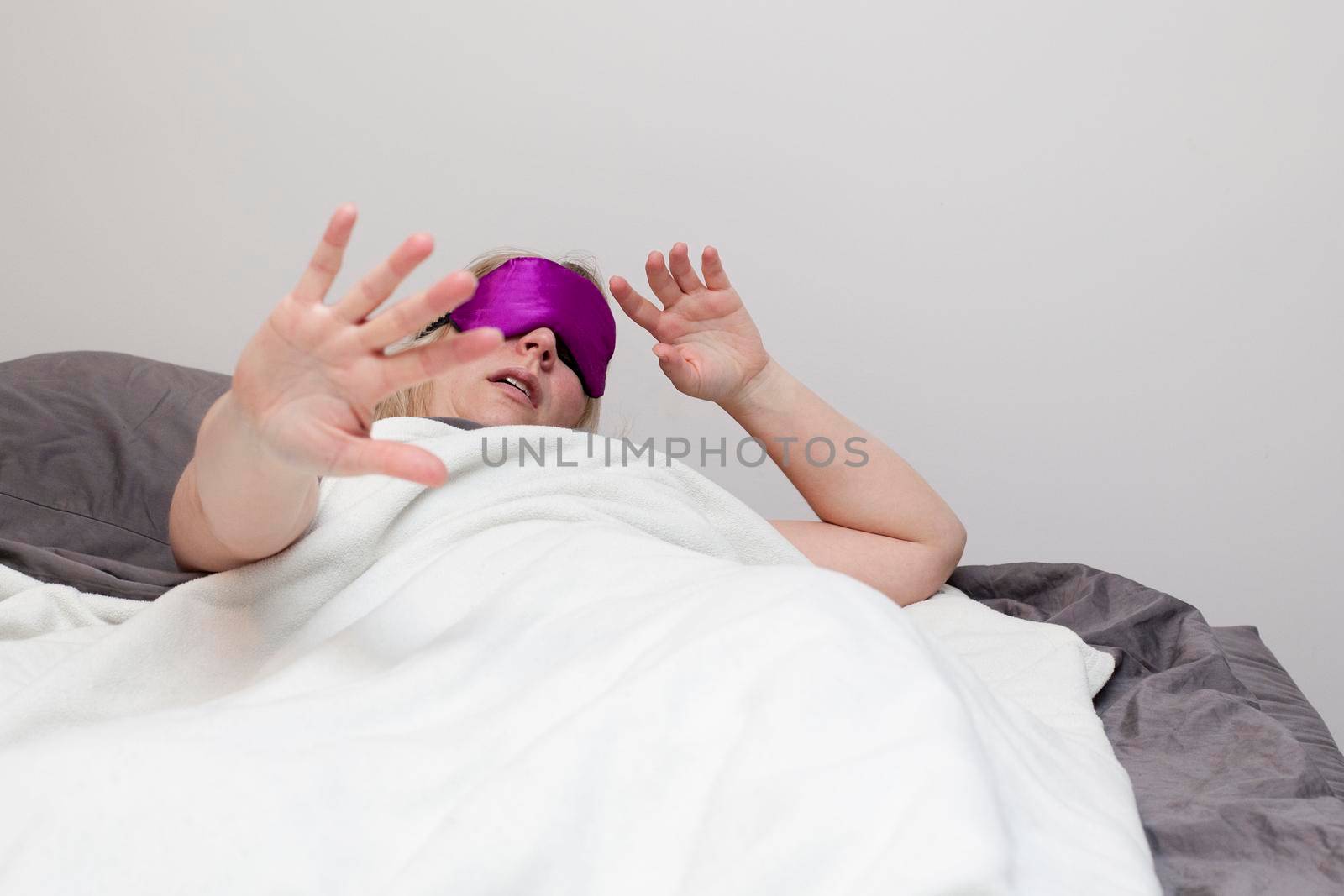 Woman in bed with hand out, telling you to back off and leave her alone