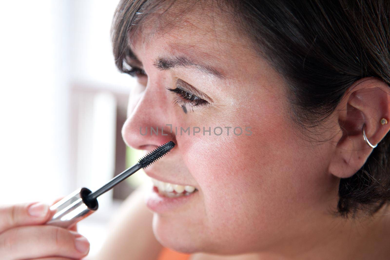 Woman's upset face as she smudges mascara 