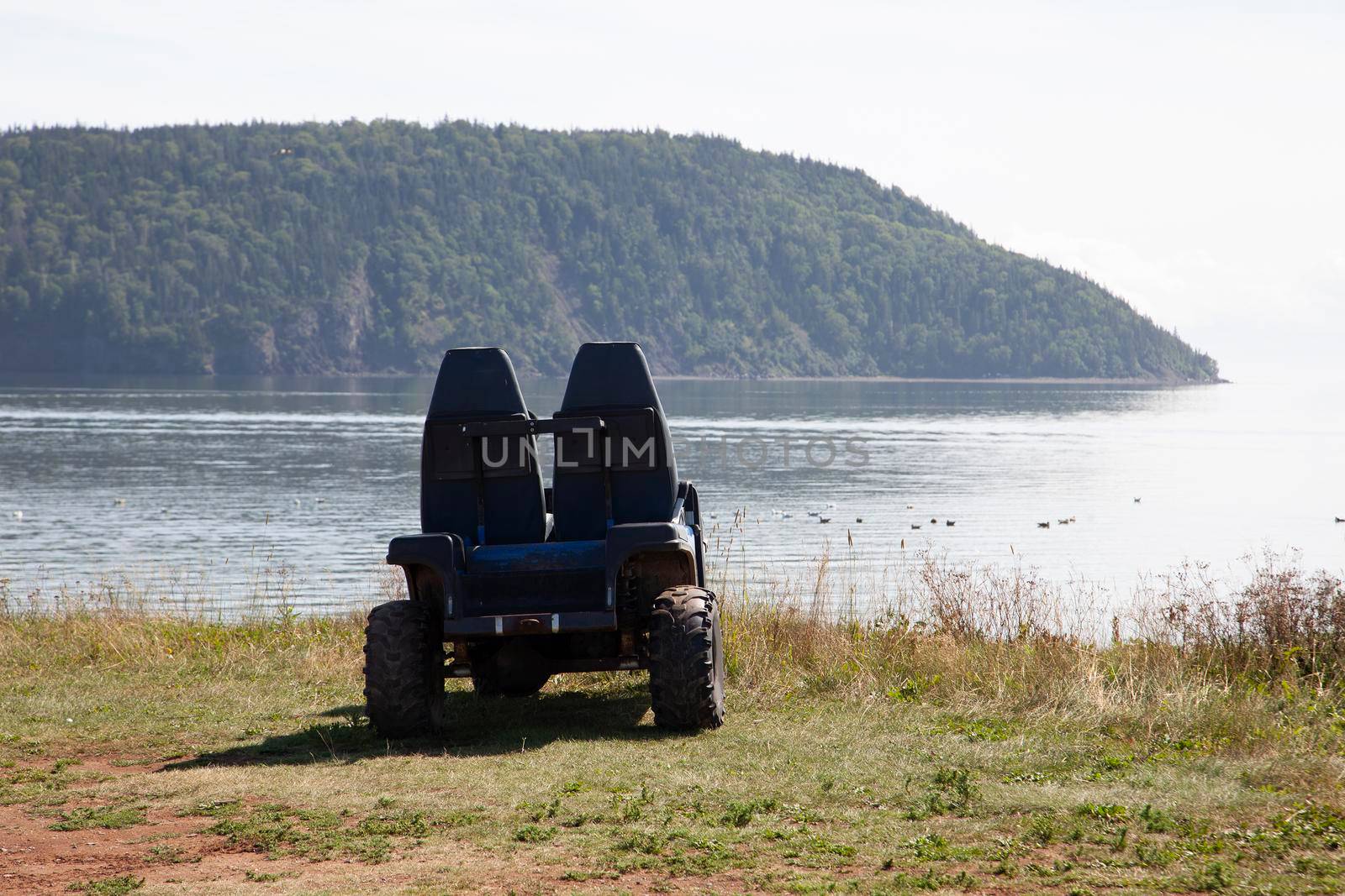  an empty ATV ready for adventure on a sandy canadian beach 