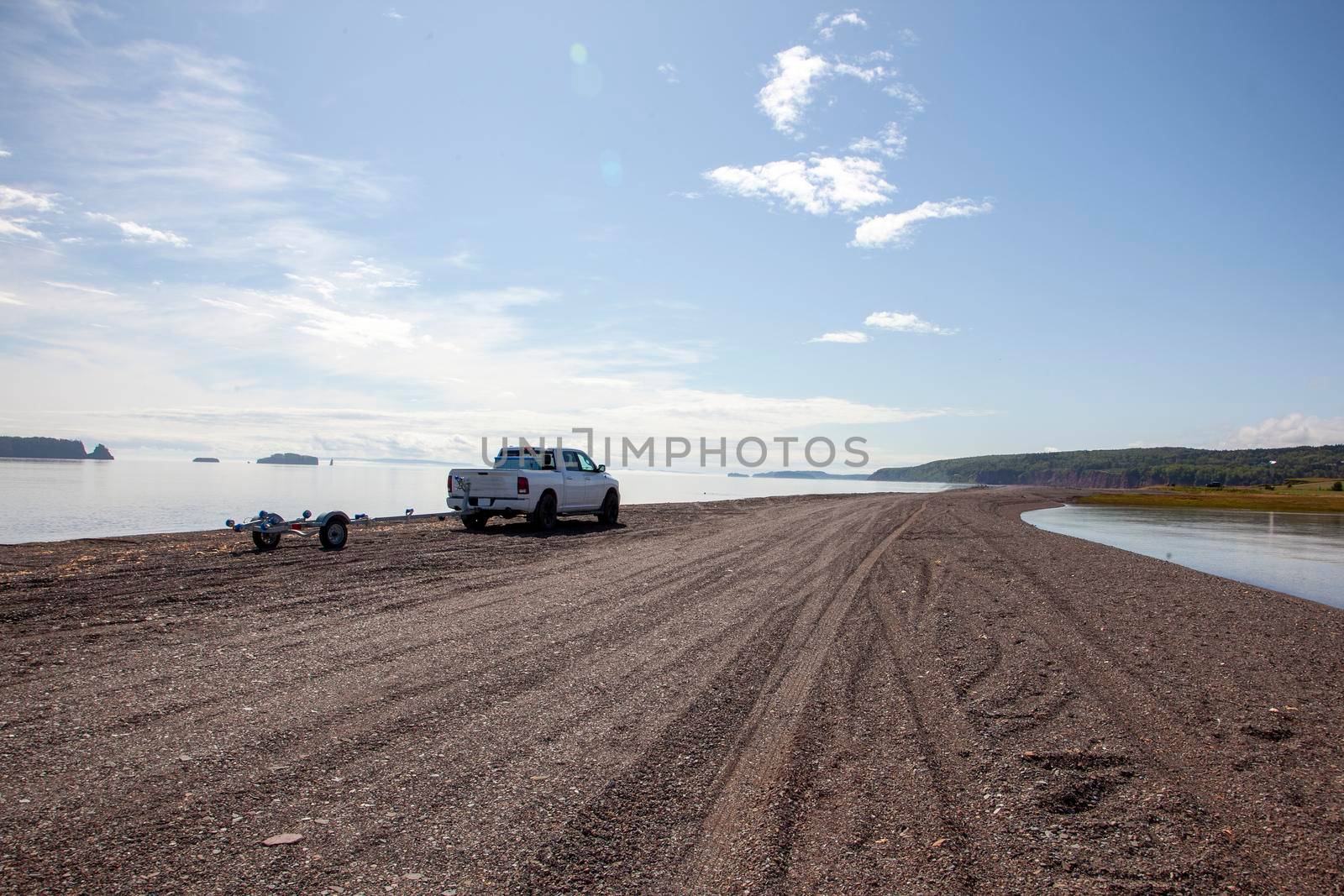 pickup truck on a rocky beach on a summer day 