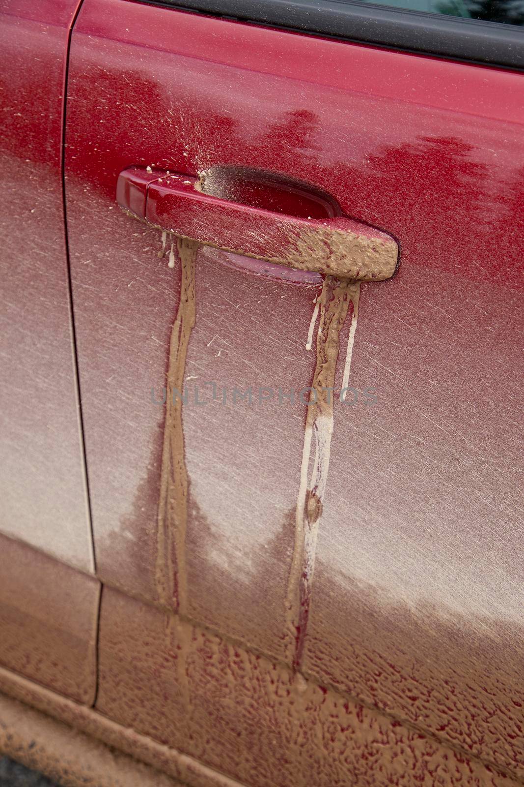 pickup truck door handle is covered in mud from off road adventuring