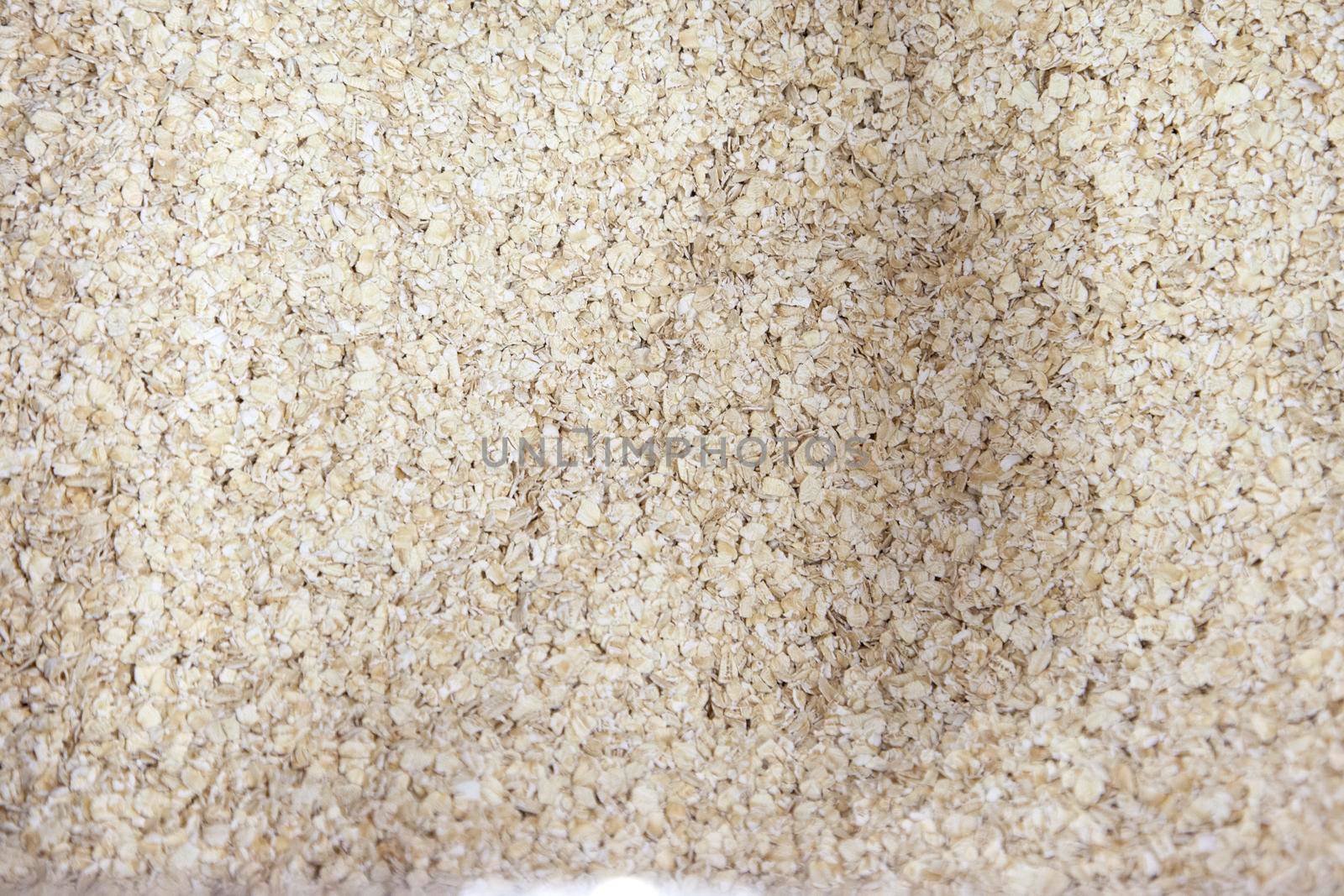 dry flakes of rolled oats breakfast food before being cooked 