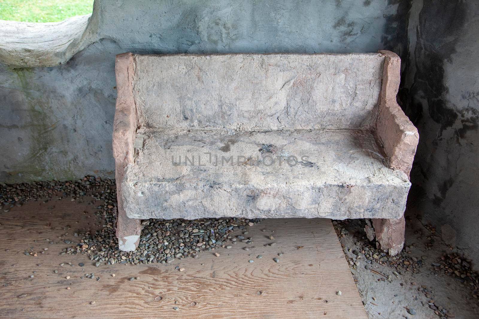 Prehistoric style bench or seat inside a stone house 