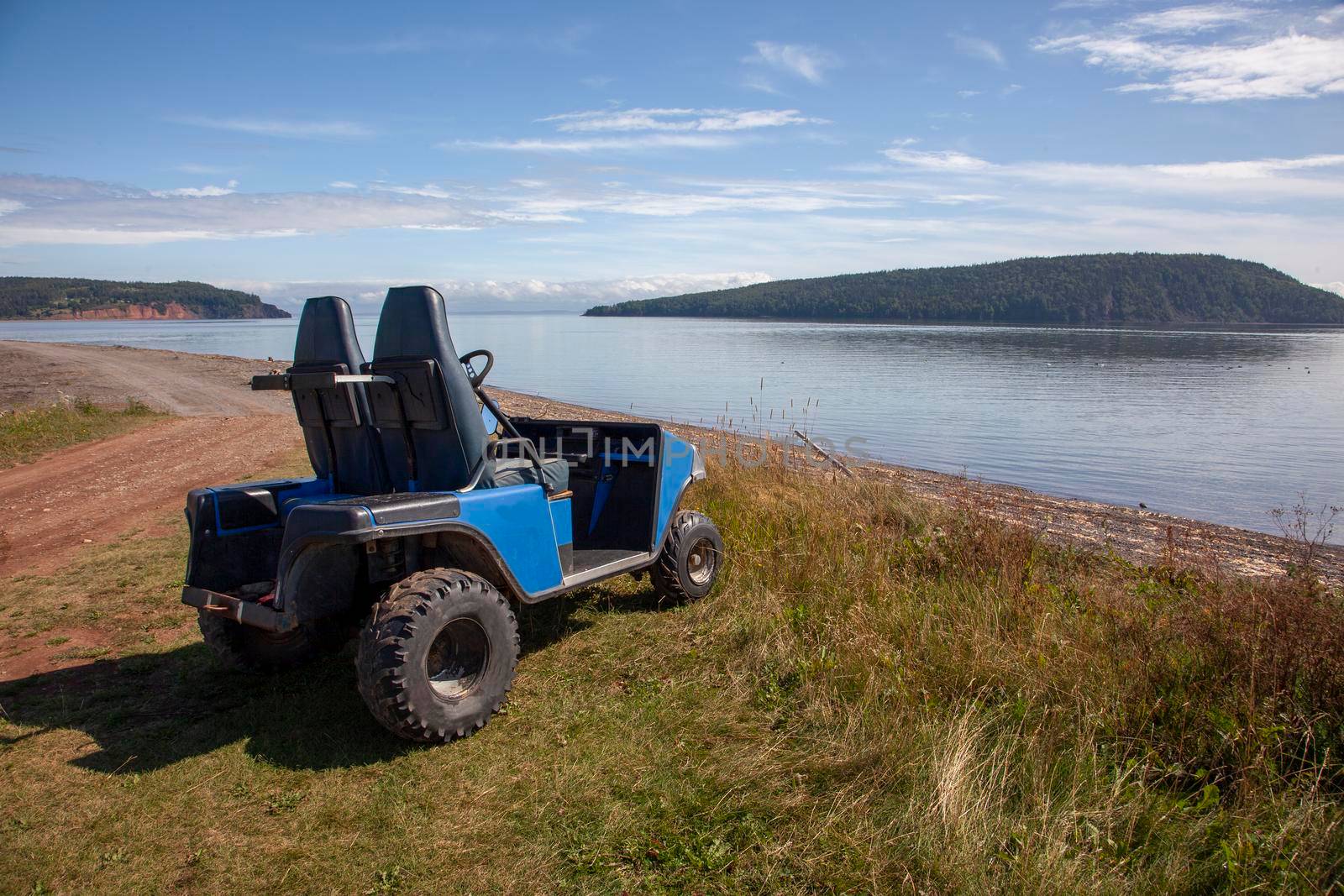 dirt road on a beach with an empty off road vehicle ready for adventure 