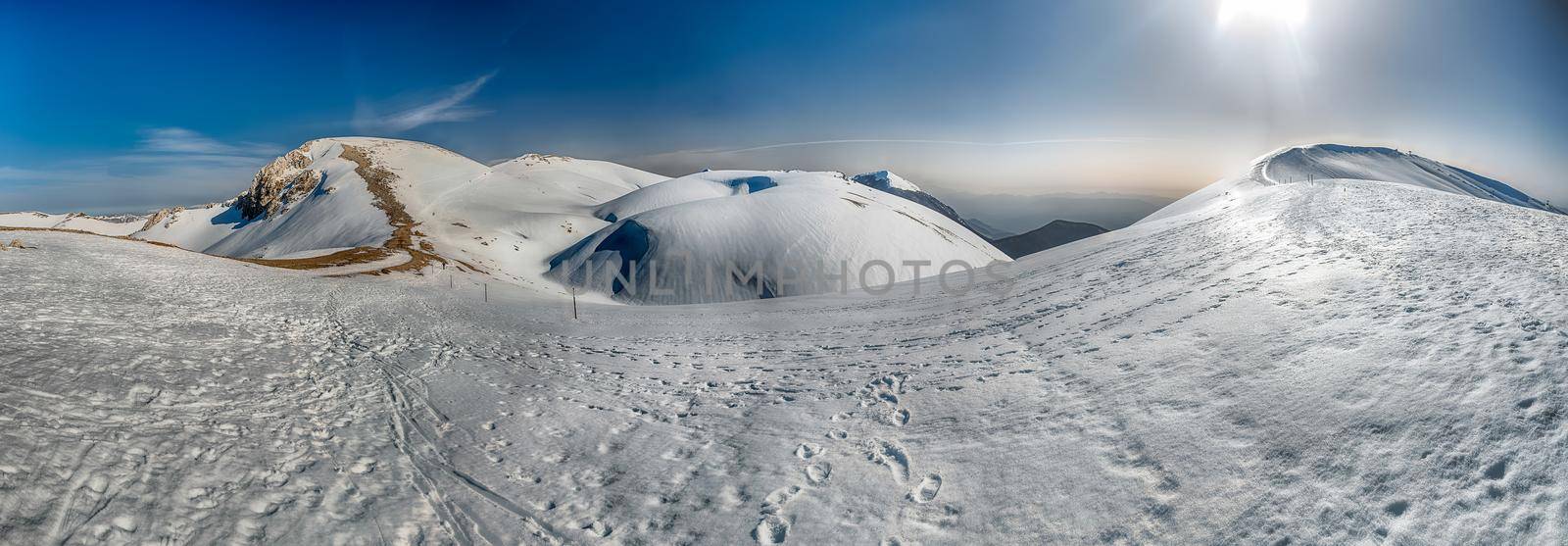Scenic winter landscape with snow covered mountains, Campocatino, Italy by marcorubino
