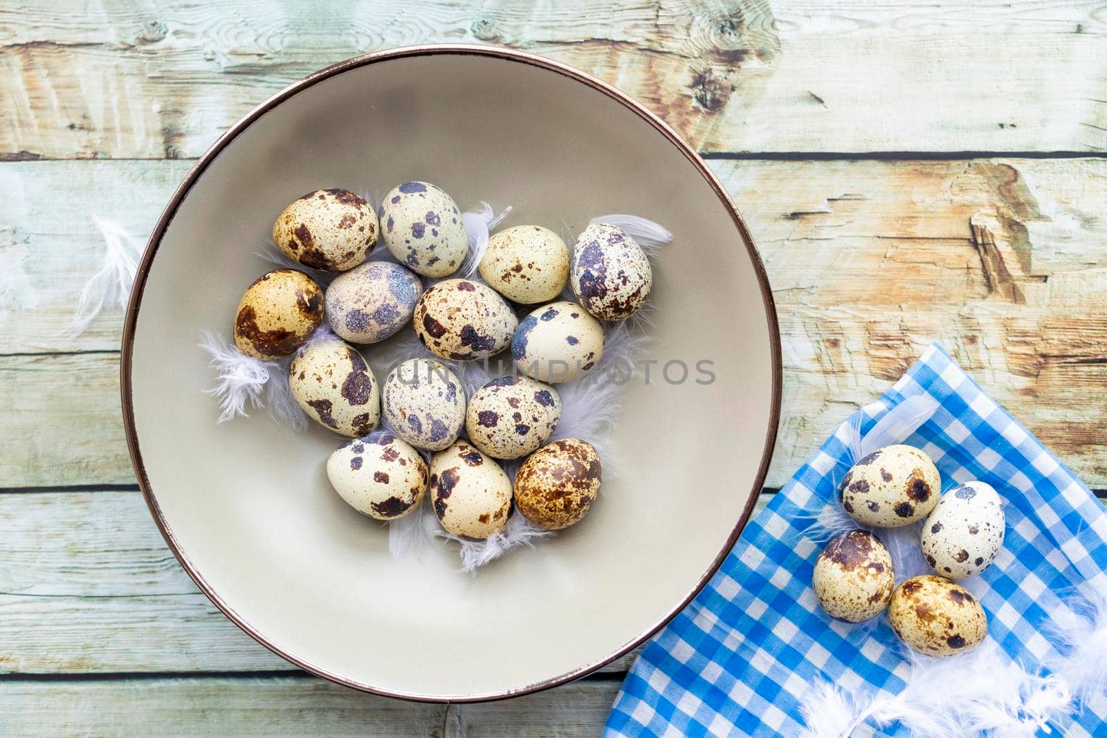 Quail eggs inside a decorative plate and on a background by eagg13
