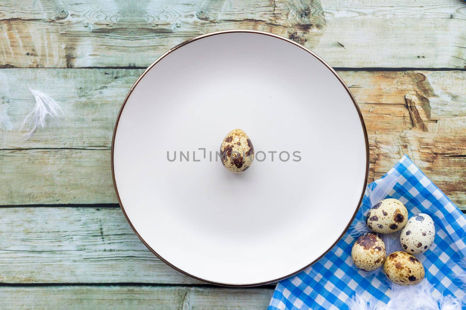 Quail eggs inside a decorative plate and on a background