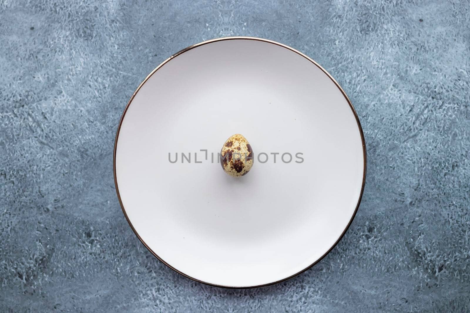 Quail eggs inside a decorative plate and on a background