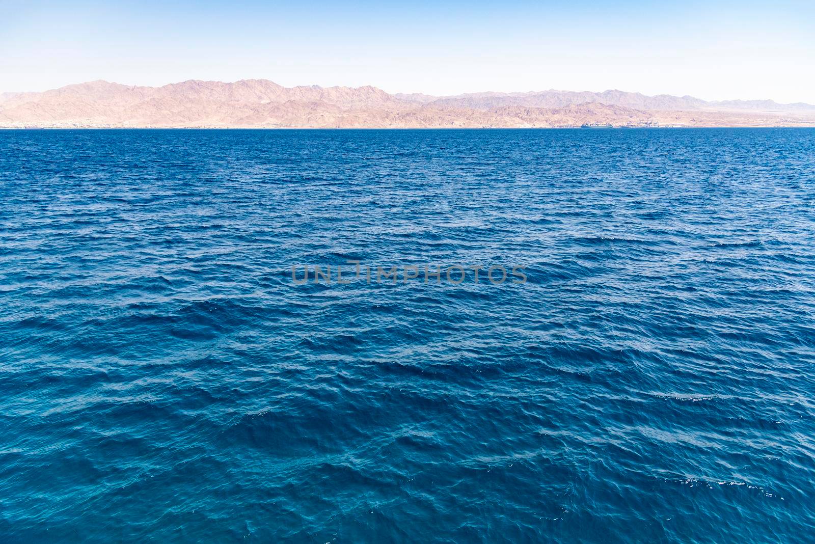 A view of the coral reef above the water. The Red Sea. Beach in the city of Eilat, Israel High angel, Mountains of Aqaba Jordan. High quality photo