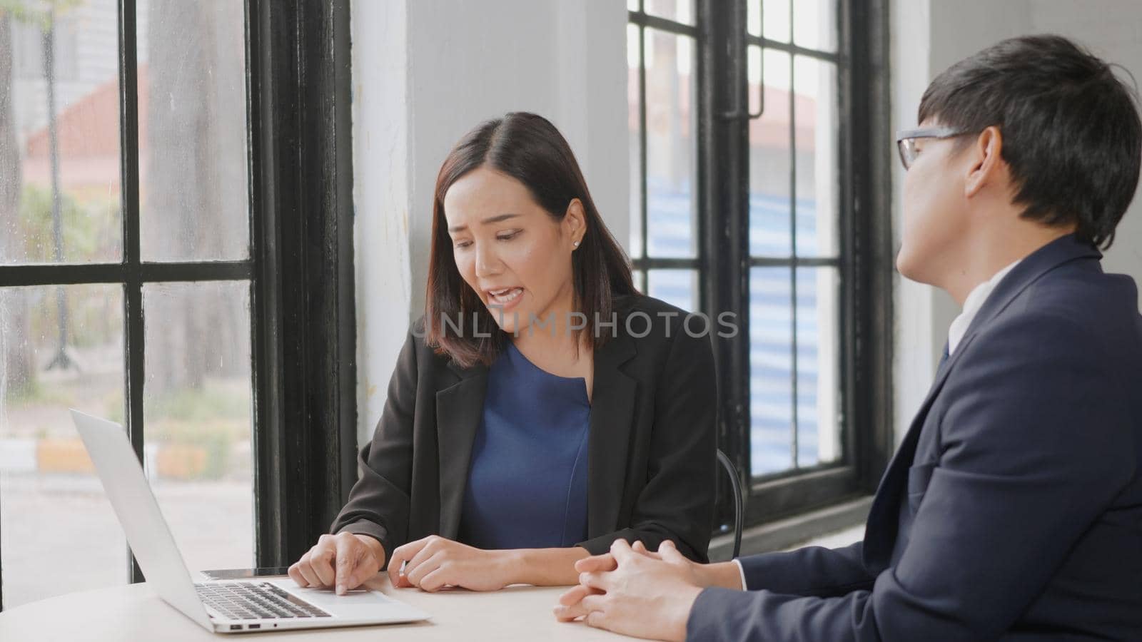 Two business people talk project strategy at office, Businessman and businesswoman Businessman discuss project planning with laptop computer, team working together at meeting room