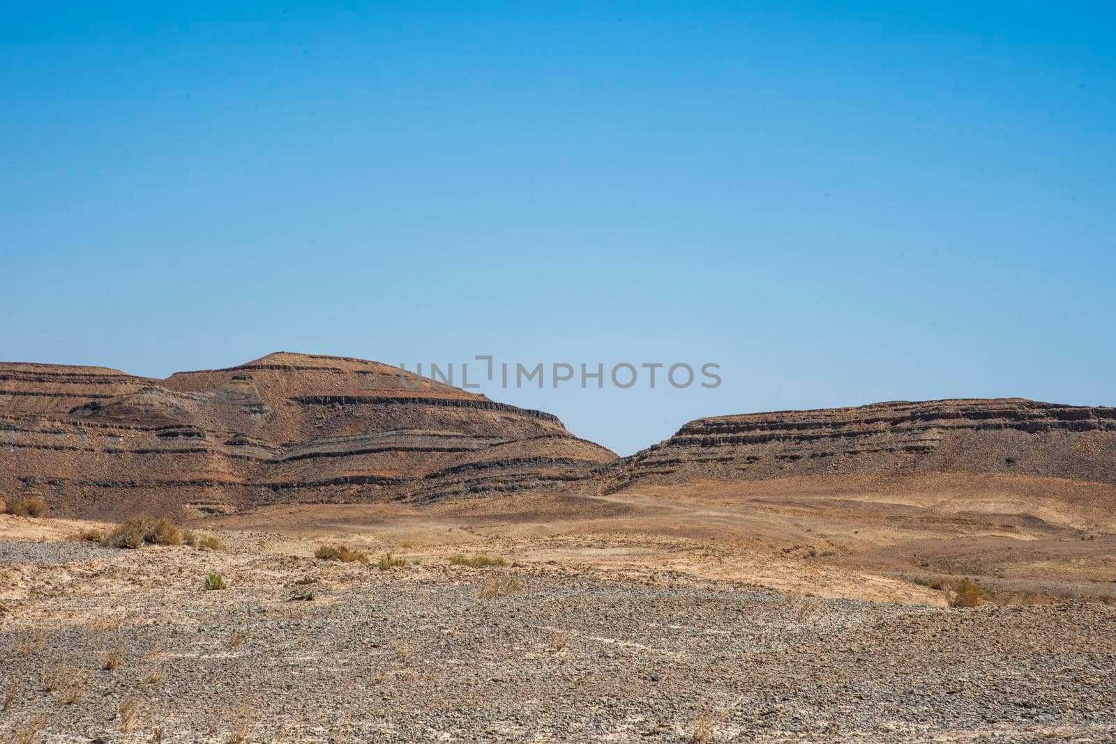 A view from the crater in the Ramon Crater. Arid desert view. White sands and a horizon of blue skies. Negev, Israel. High quality photo