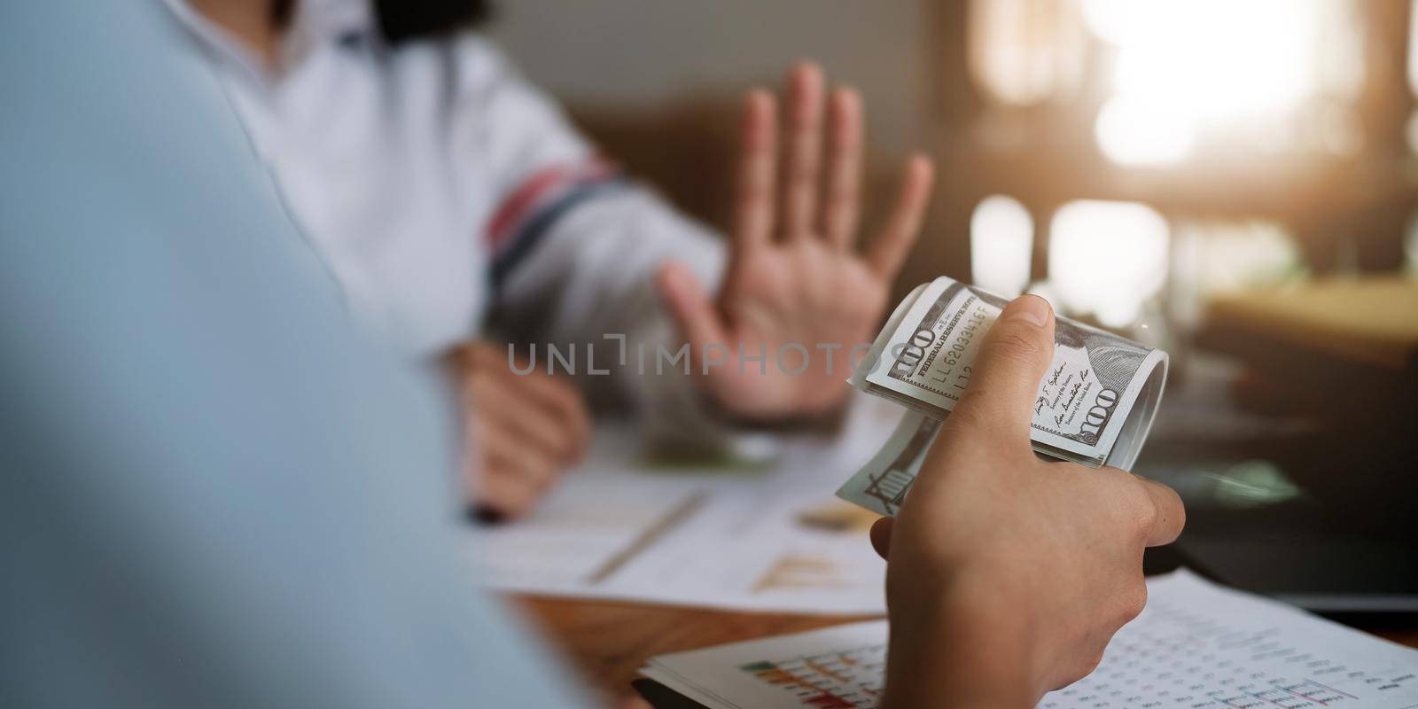 Businesswoman rejecting money in white envelope offered by his partner in the dark - anti bribery concept. by nateemee