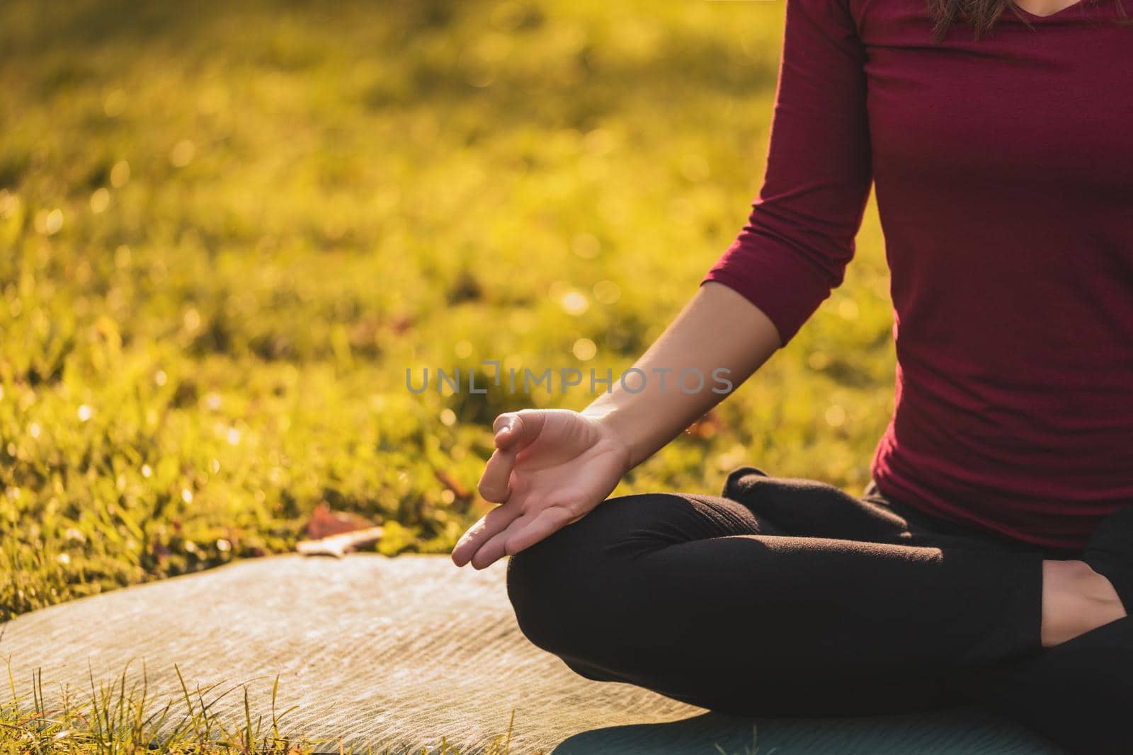 Close up image of woman  exercising yoga in the nature,Padmasana/Lotus position.