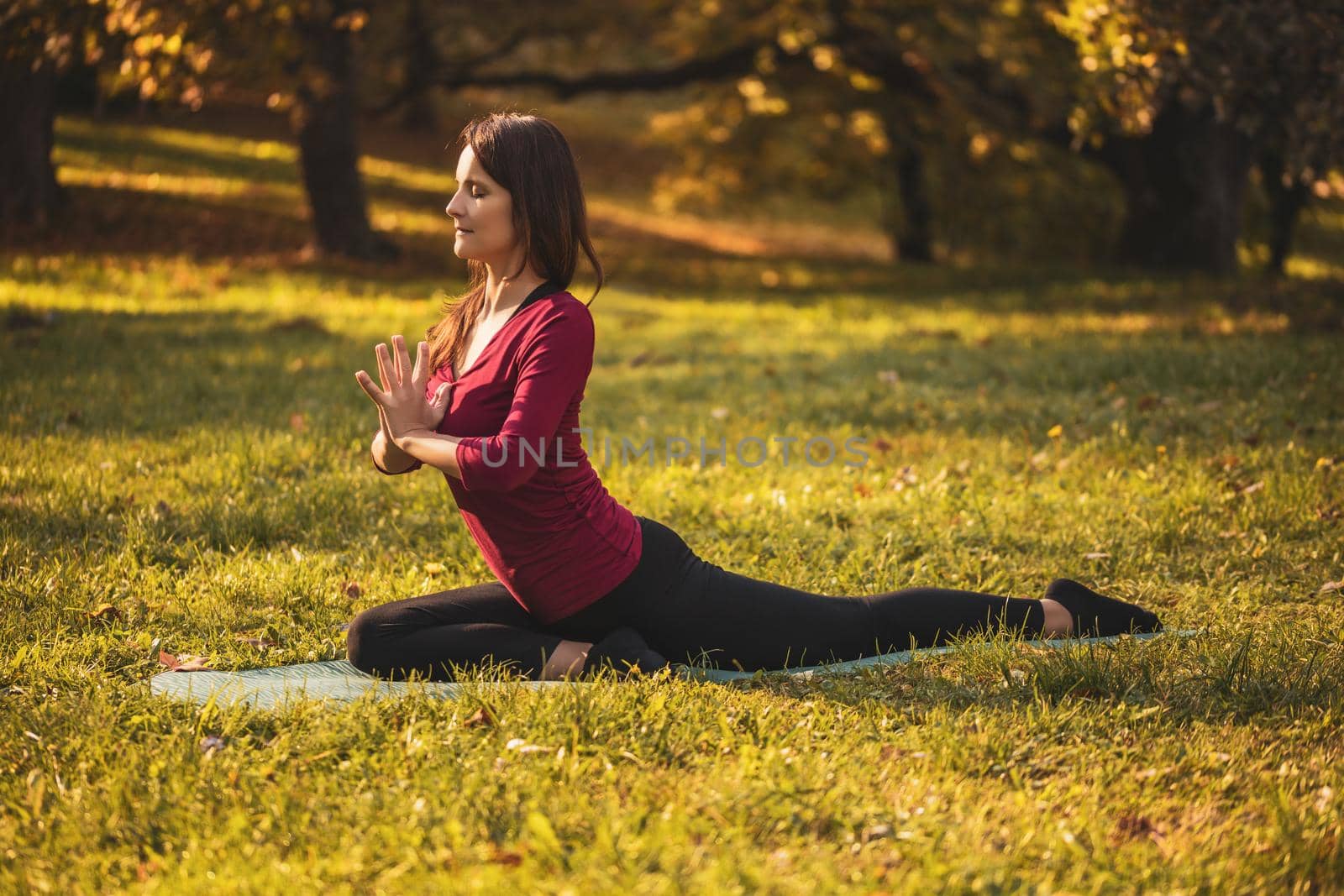 Woman doing yoga in the nature by Bazdar