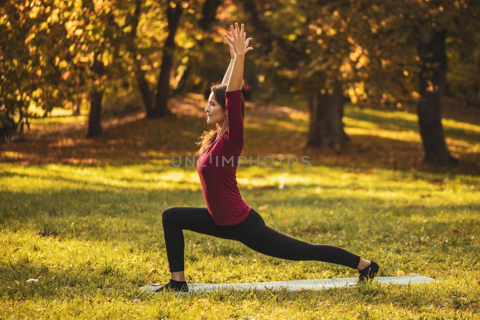 Woman doing yoga in the nature by Bazdar