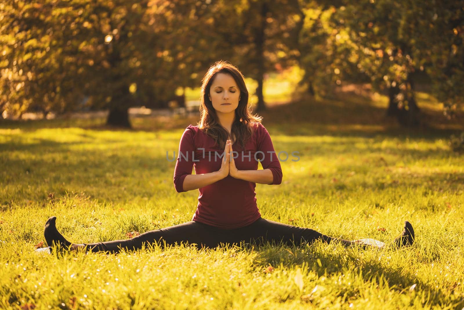 Beautiful woman sitting in nature and meditating.