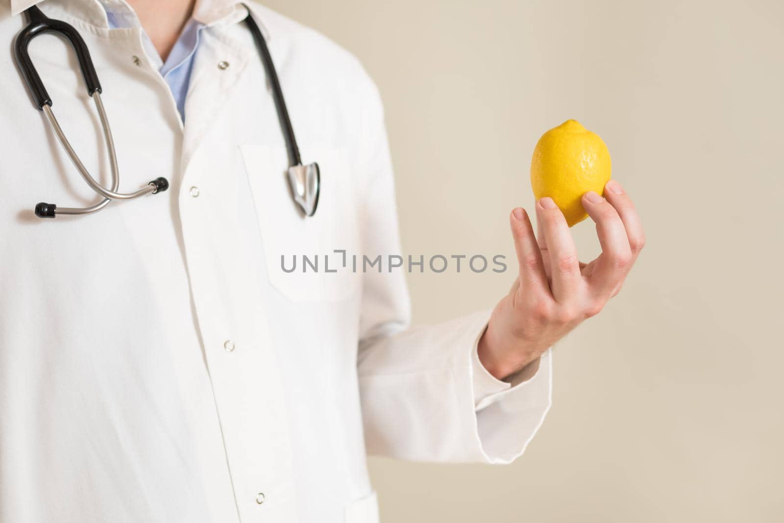 Male doctor holding lemon by Bazdar
